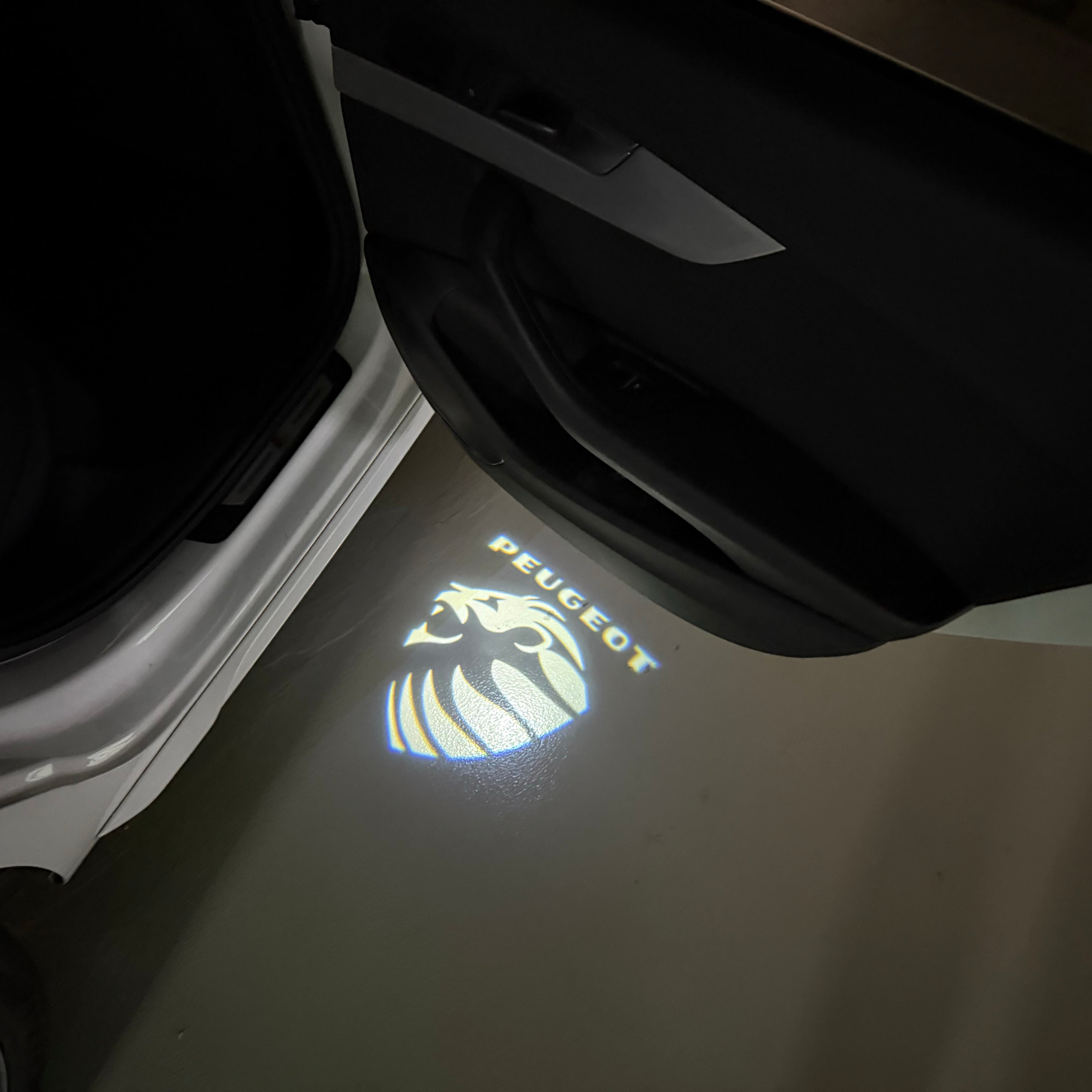 PEUGEOT ORIGINAL  LOGO PROJECTOT LIGHTS (quantity 1 = 1 sets/2 door lights) Nr.6024q67