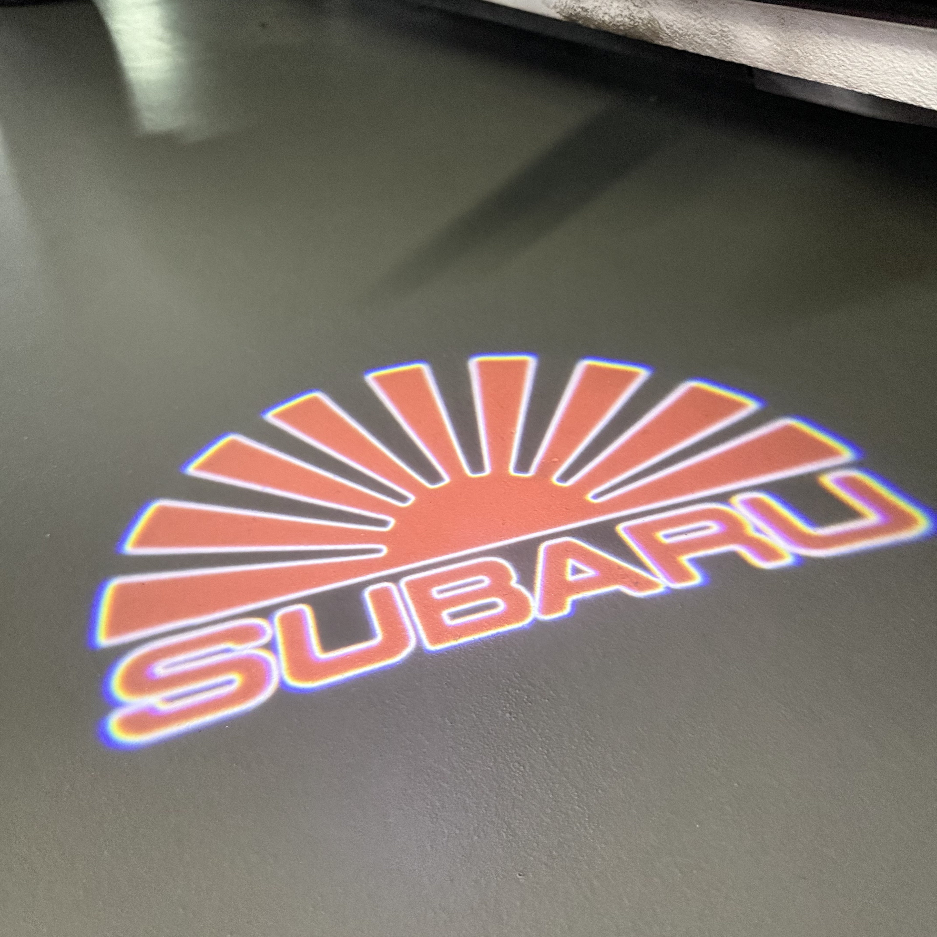 SUBARU ORIGINAL LOGO PROJECROTR LIGHTS (quantity 1 = 1 sets/2 door lights) Nr.7